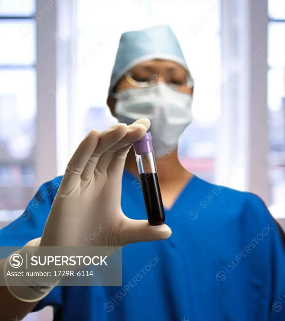 Doctor holding test-tube of liquid