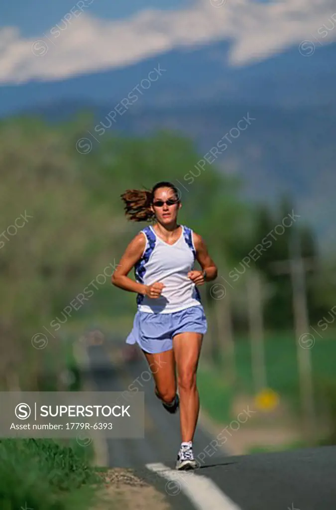 Woman jogging on paved road