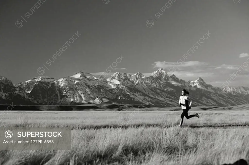 Woman jogging through meadow