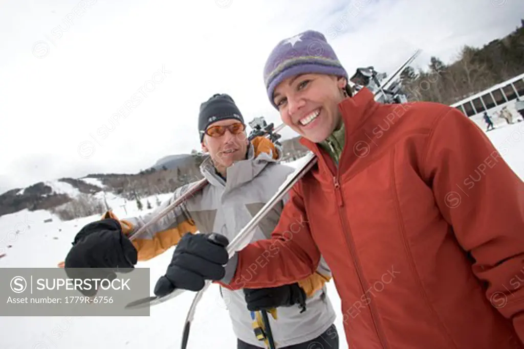 Couple carrying skis