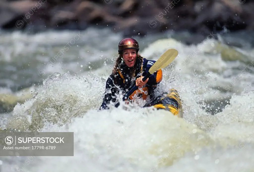 Woman whitewater kayaking