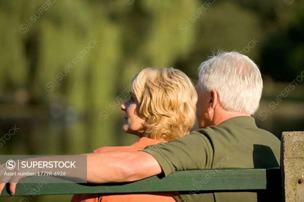 Senior couple cuddling on bench