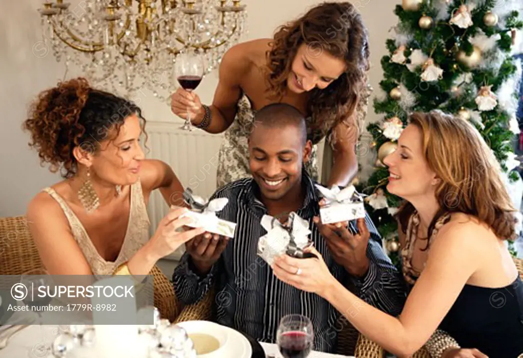 People exchanging gifts at Christmas party