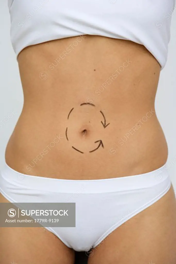 Woman's bare torso with arrow around navel