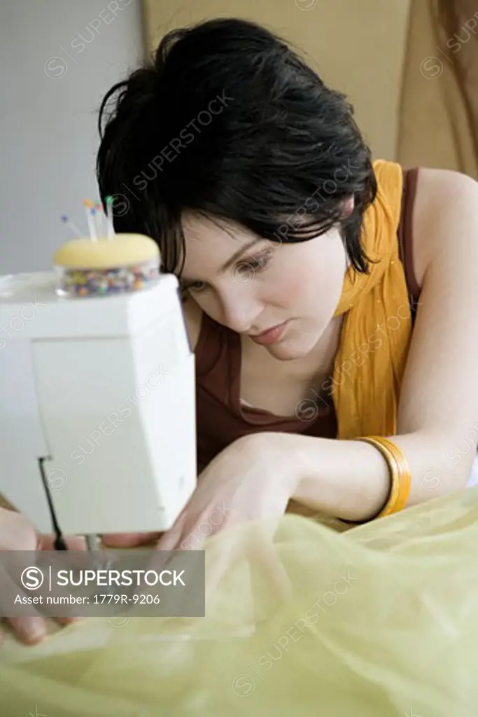 Seamstress using sewing machine