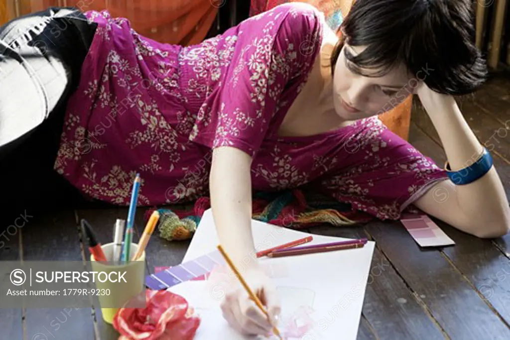 Female designer sketching on floor