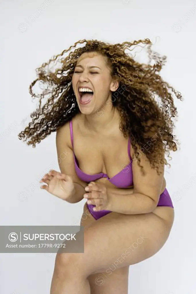 Woman laughing wearing bra and panties