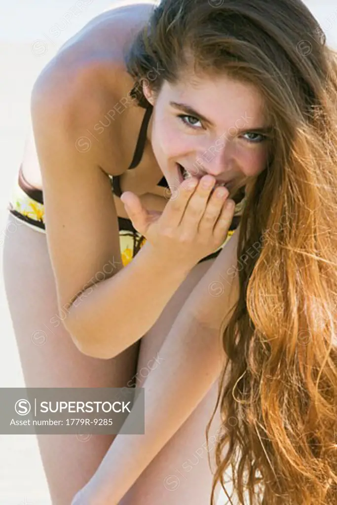 Young woman in bathing suit laughing