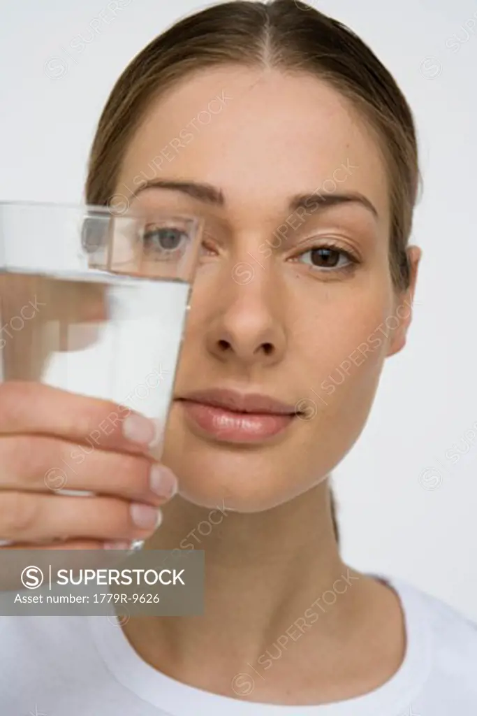 Woman holding out glass of water