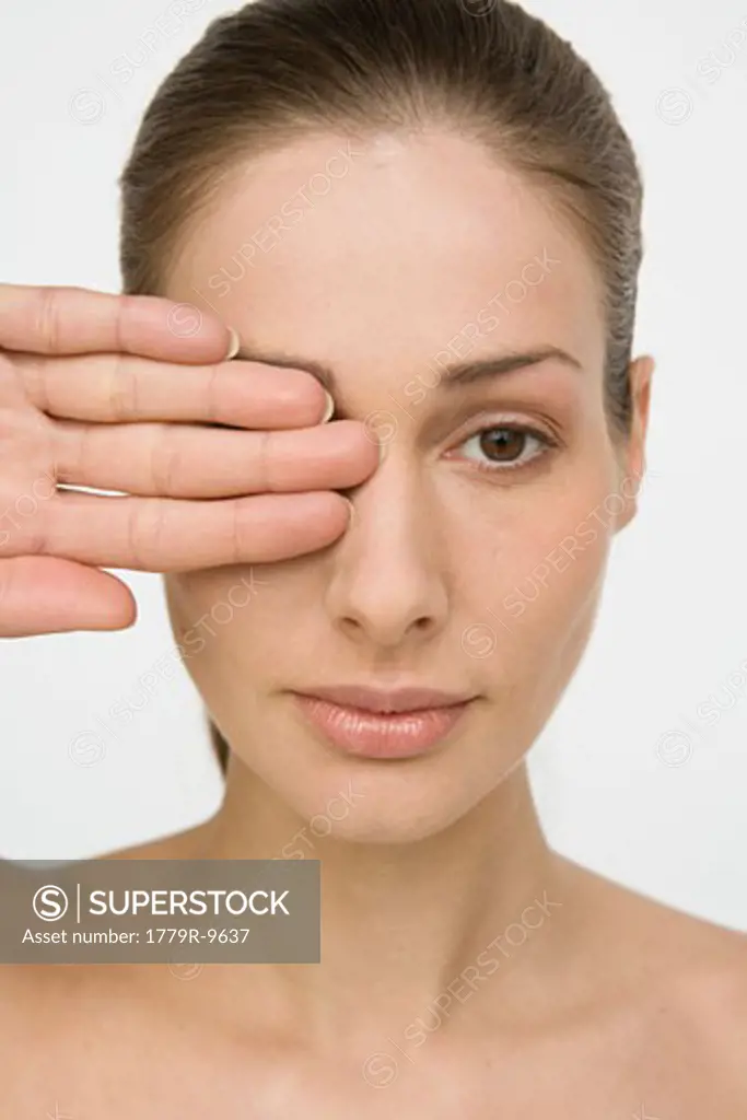 Woman covering one eye