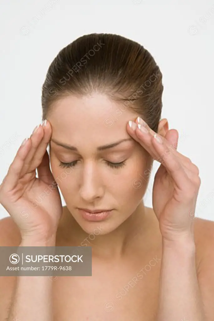 Young woman rubbing her forehead