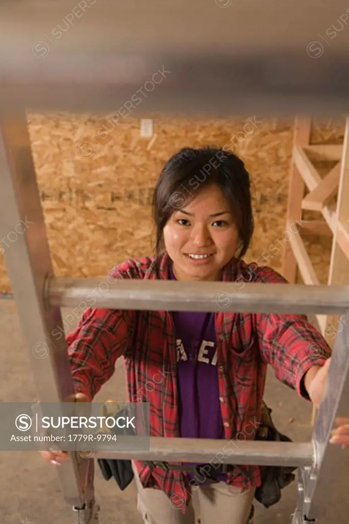 Teenage girl climbing ladder