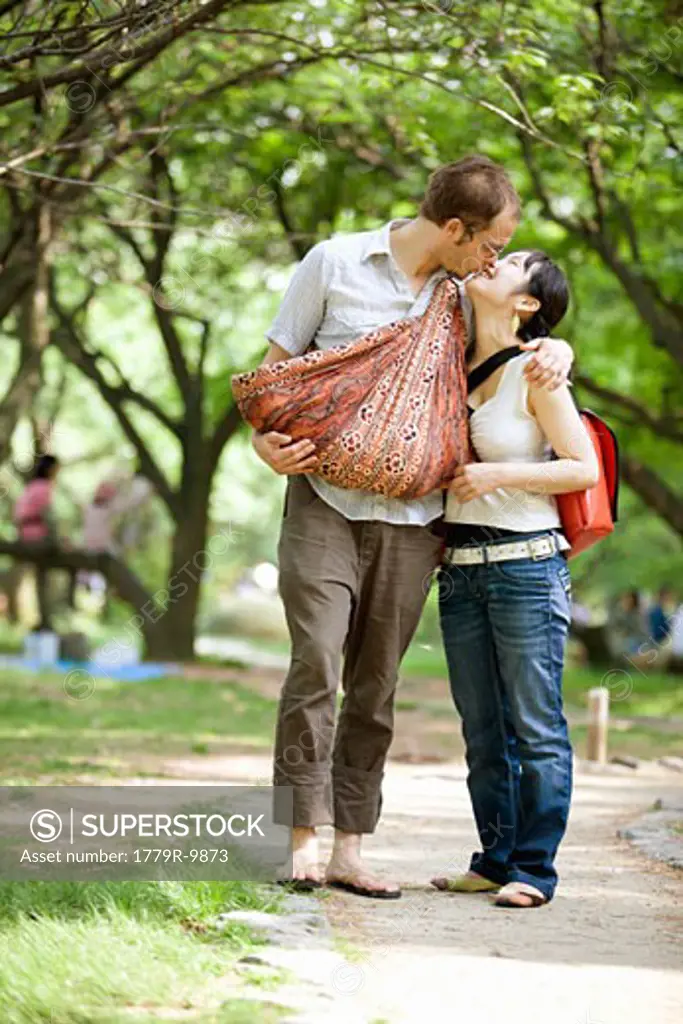 Couple with baby in park