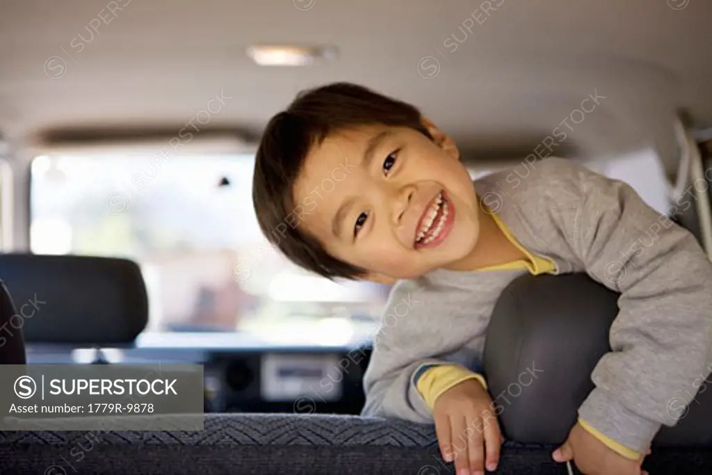 Boy in backseat of car