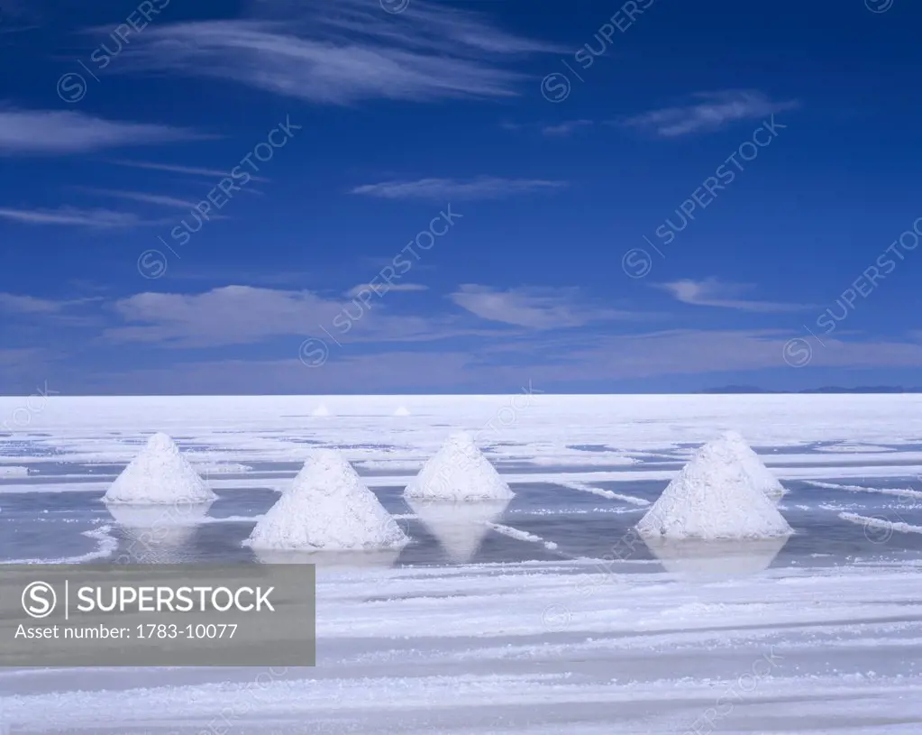 White piles of salt in stark landscape, Uyuni salt flat, Bolivia