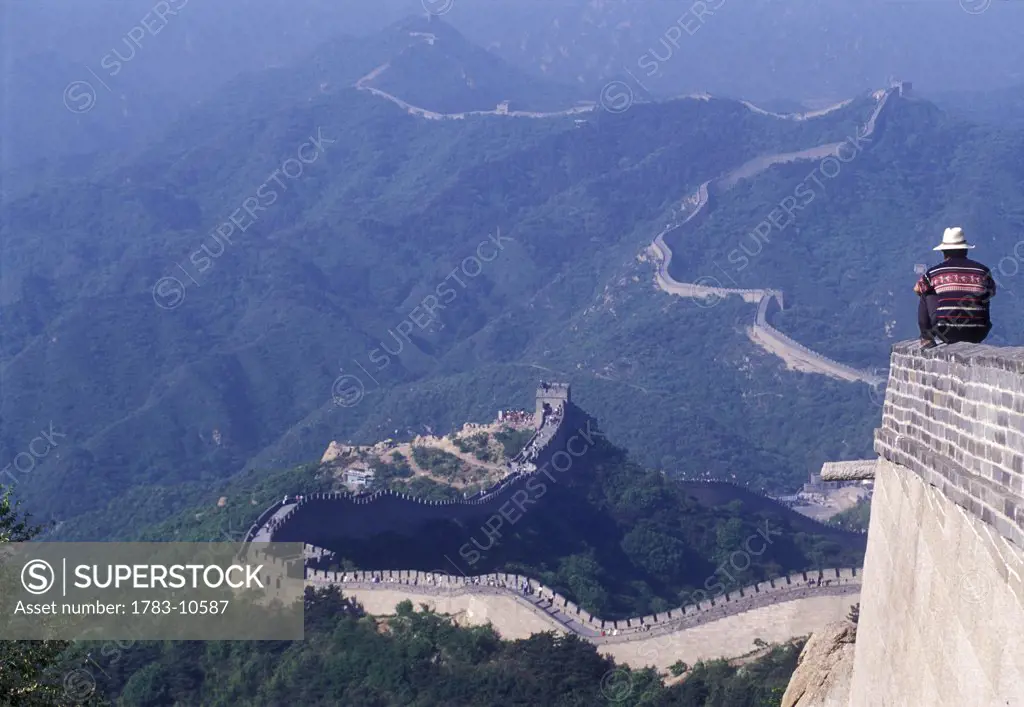 Man sitting on wall of Great Wall of China, China