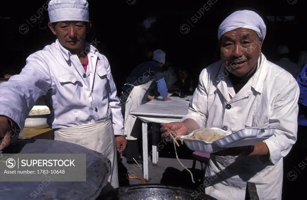 Two chefs making noodles, Beijing, China.