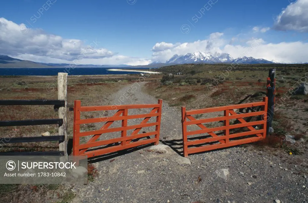 Red gate over dirt road, Torres del Paine, Chile