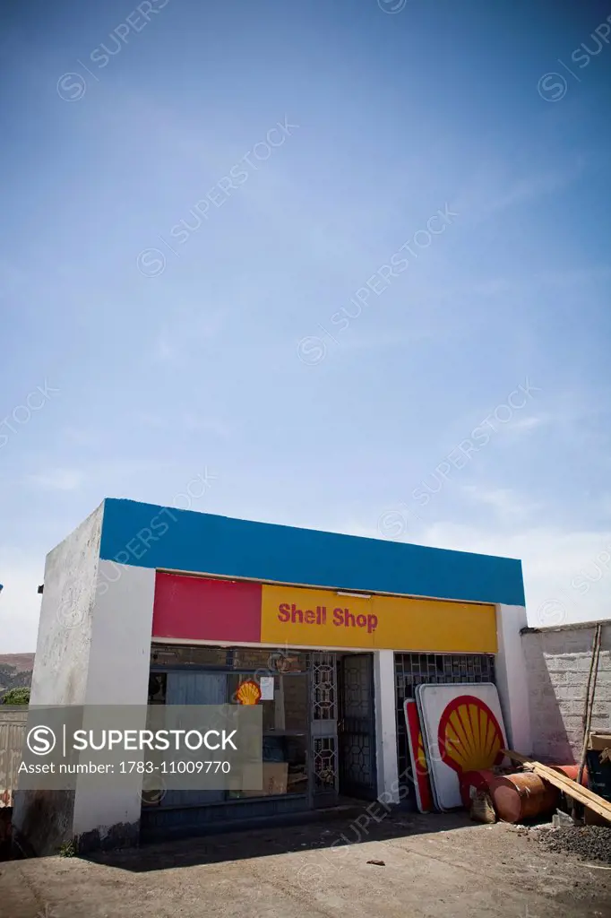 Small roadside petrol station with handpainted shell sign; Ethiopia