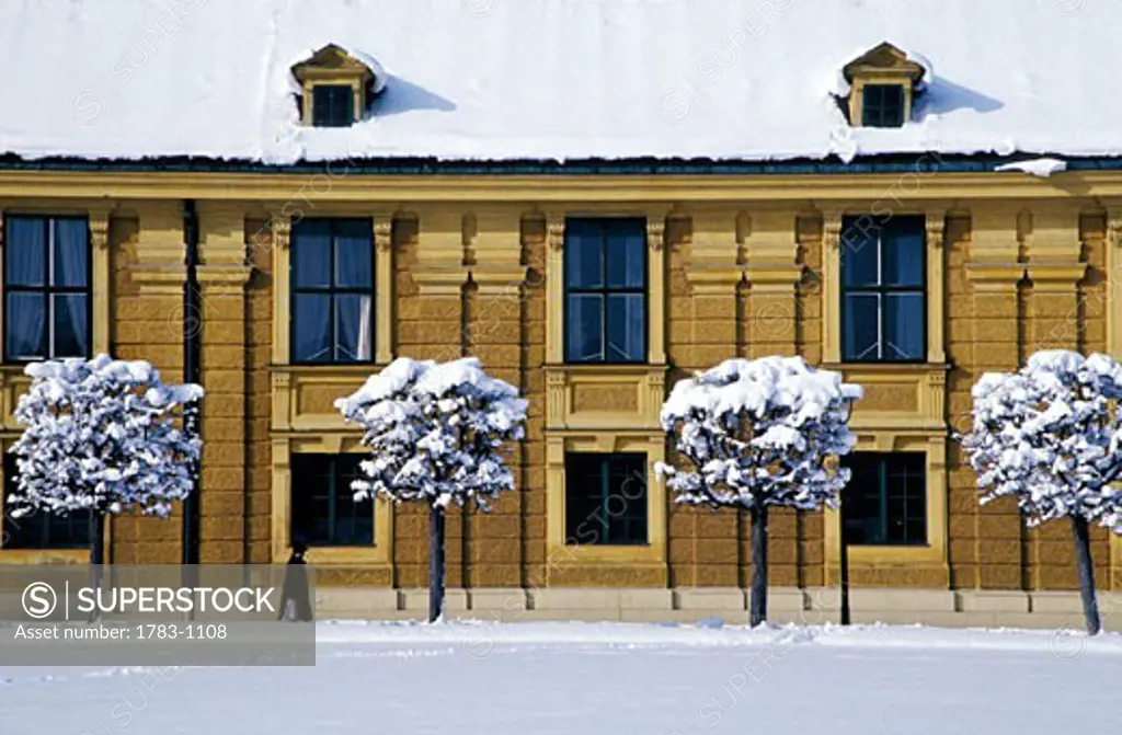 Schonbrunn Palace, Vienna, Austria, person walking in annex to palace in the snow. 