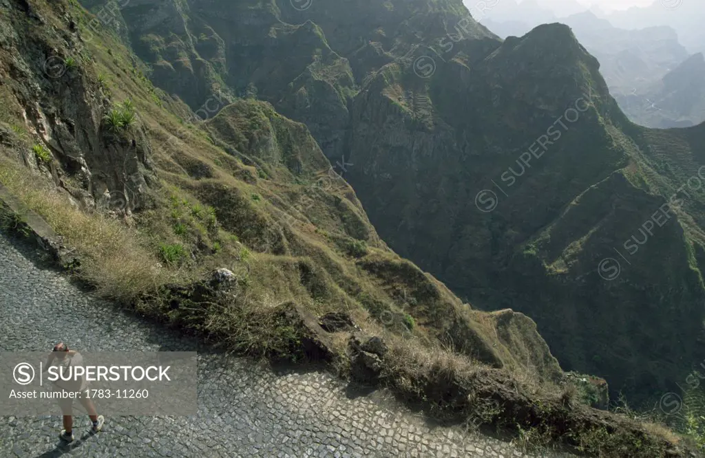 Tourist on road in mountains, Santo Antao, Cape Verde.