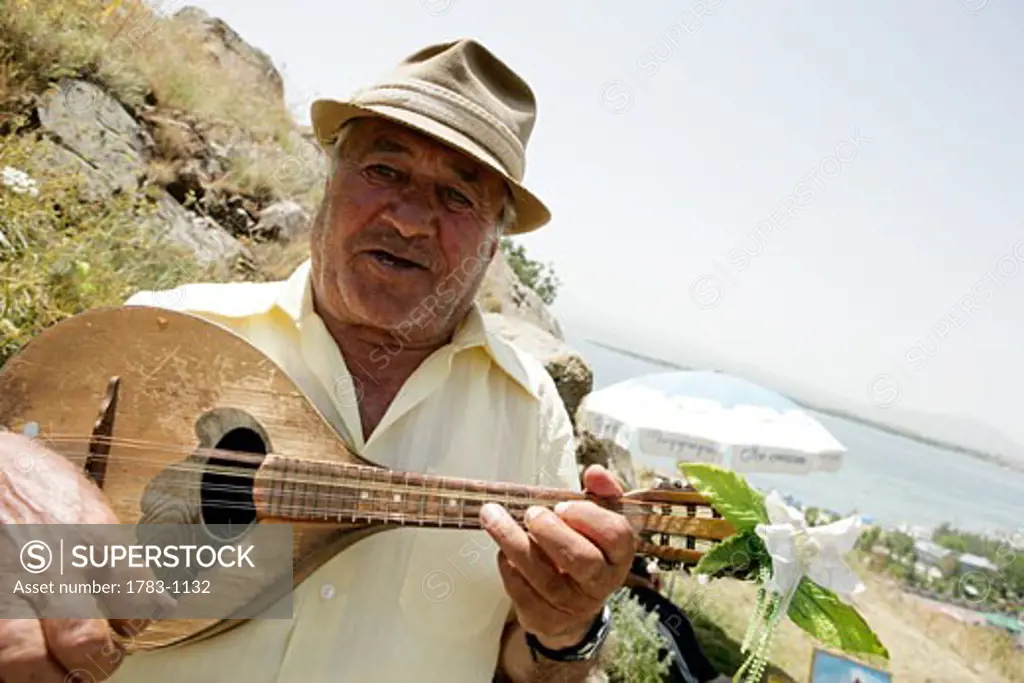 Musician playing above Lake Sevan, Armenia