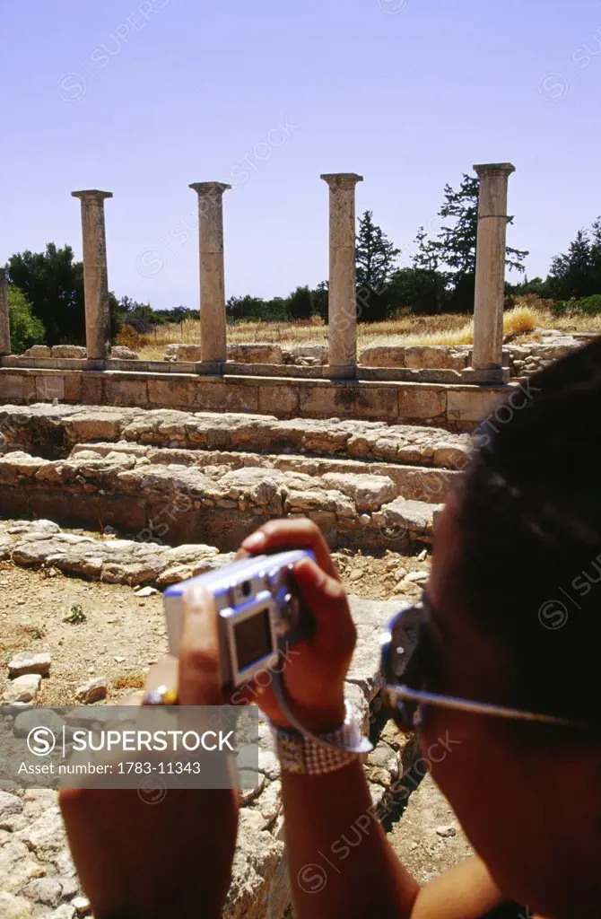 Tourists taking pictures with a digital camera at Sanctuary of Apollon Ylatis, Cyprus 