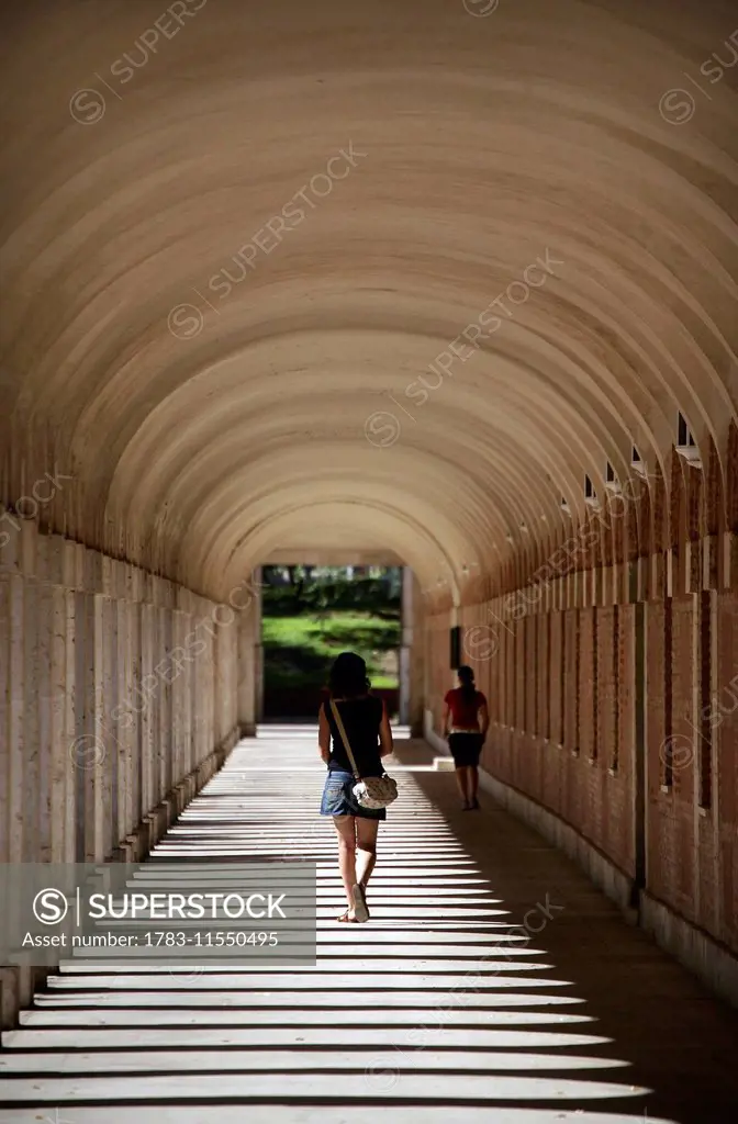 A Woman Walking In Arcade Of The Royal Palace