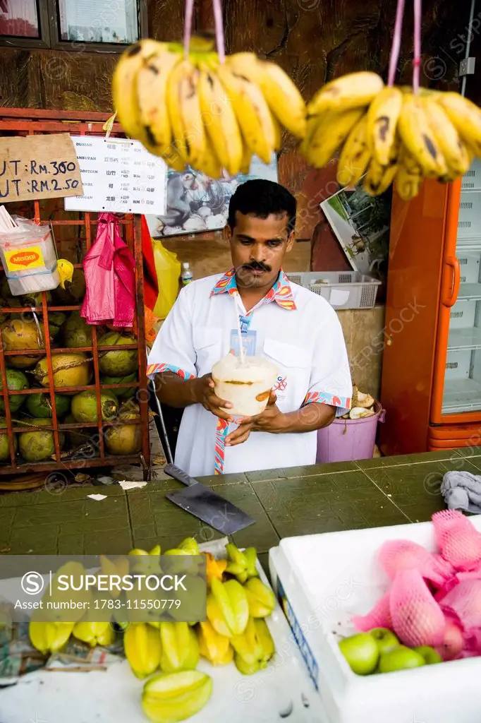 Fruit Stall Owner Serving Coconut Milk