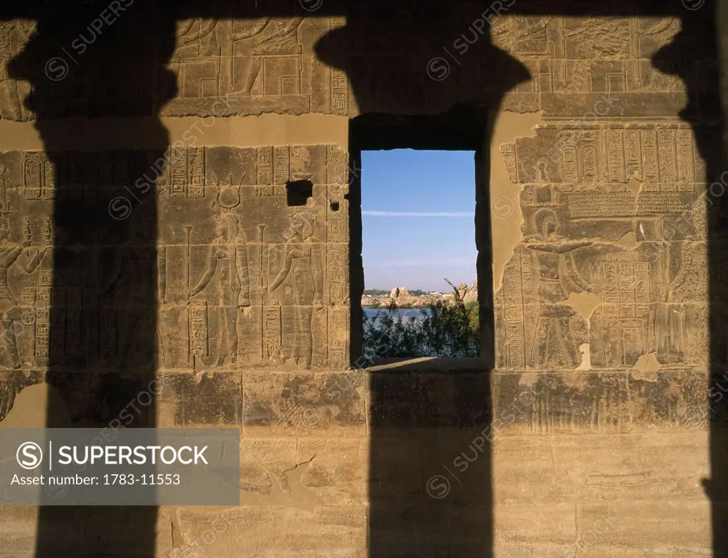 Wall of West Colonnade covered in reliefs and hieroglyphs, Temple of Isis, Philae Island, near Aswan, Egypt.