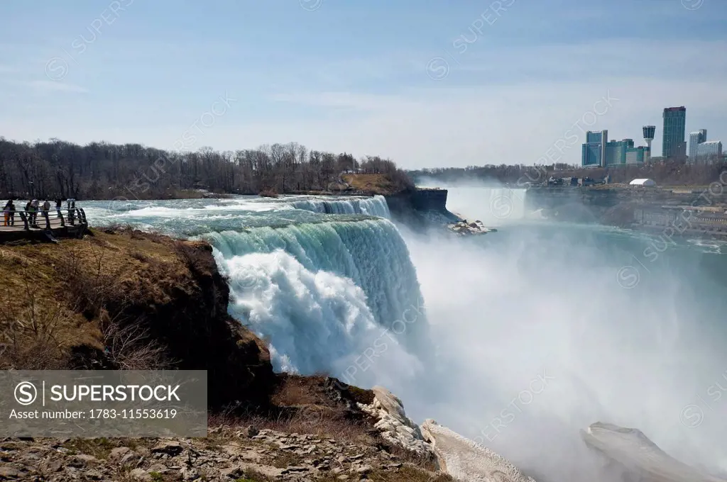 Tourists Enjoying The View Of Niagara Falls, Ontario And New York Border, Canada And United States Of America
