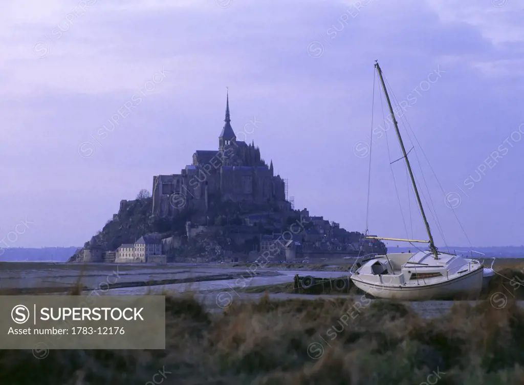 Mont Saint Michel with sailboat in foreground, Normandy, France