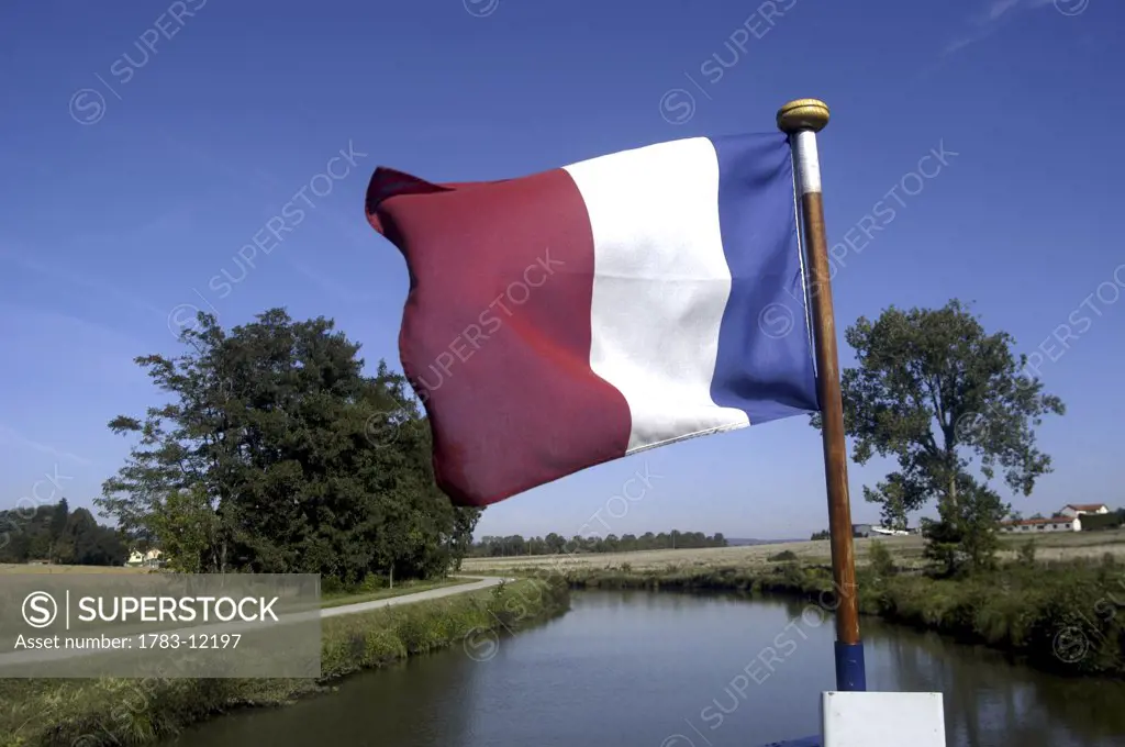 A French Peniche, with French flag, on Canal Due Centre, Canal du Centre, Burgundy, France