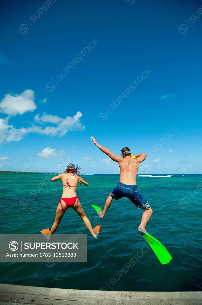Snorkellers jumping into the waters off Uplulu Island; Upulu, Samoa