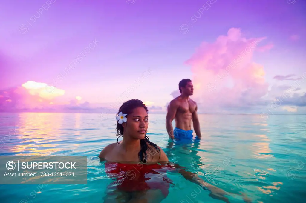 Samoan couple bathing in turquoise waters off Savaii Island; Samoa
