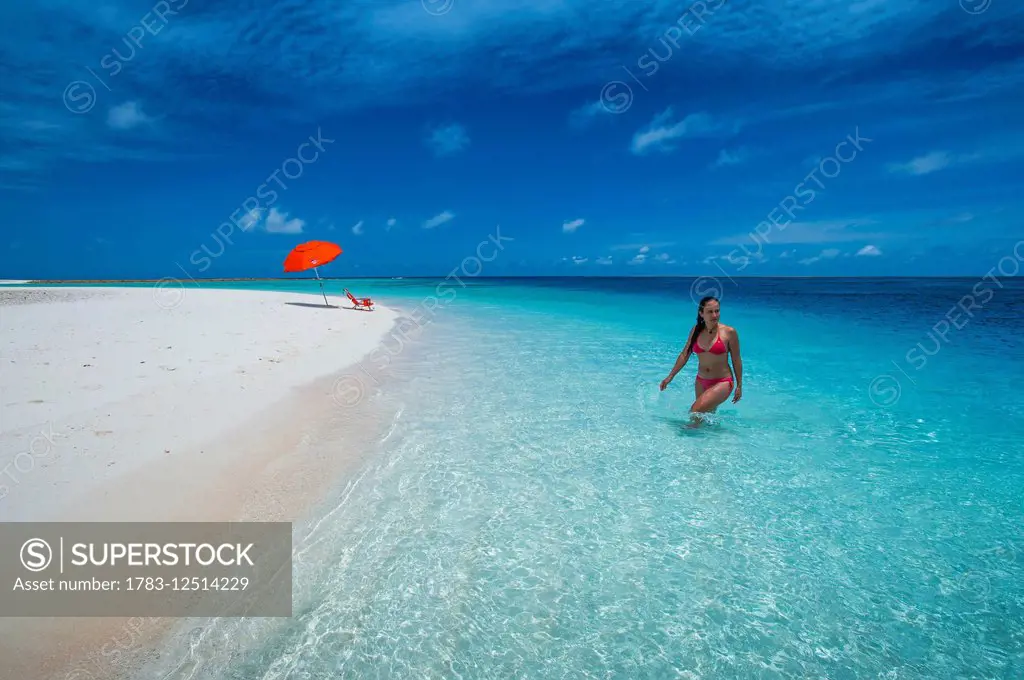 A woman wading in the pristine waters; Marshall Islands