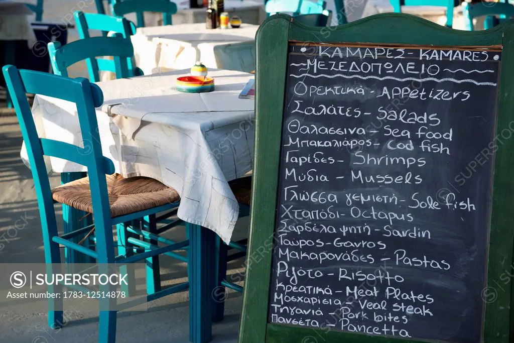 A chalkboard menu at a taverna; Kamares, Sifnos, Cyclades, Greek Islands, Greece