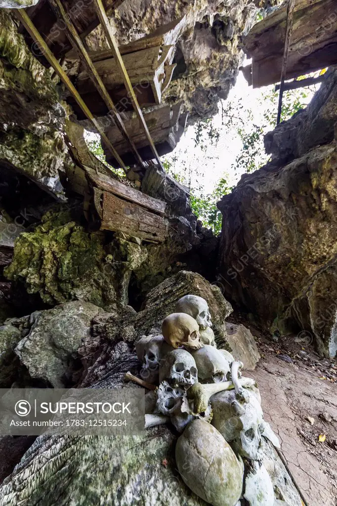 Skulls and wooden coffins in a burial cave, Tampangallo, Toraja Land, South Sulawesi, Indonesia
