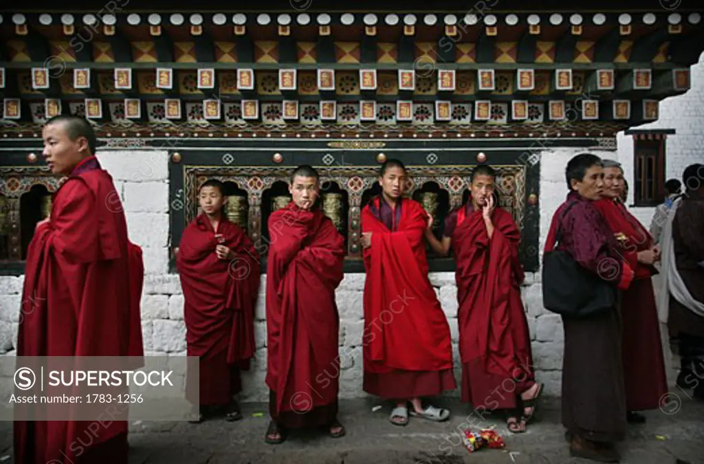 Buddhist monks by prayer wheels, Thimpu , Bhutan