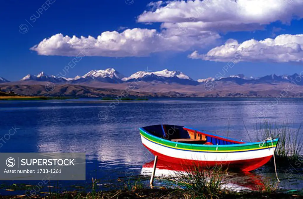 Fishing boat on lake and Cordillera Real, Lake Titicaca, Bolivia 