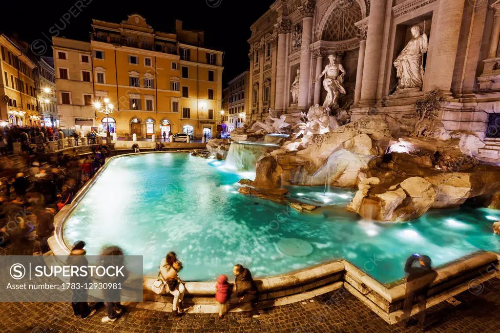 Tourists at Trevi Fountain at nighttime; Rome, Italy