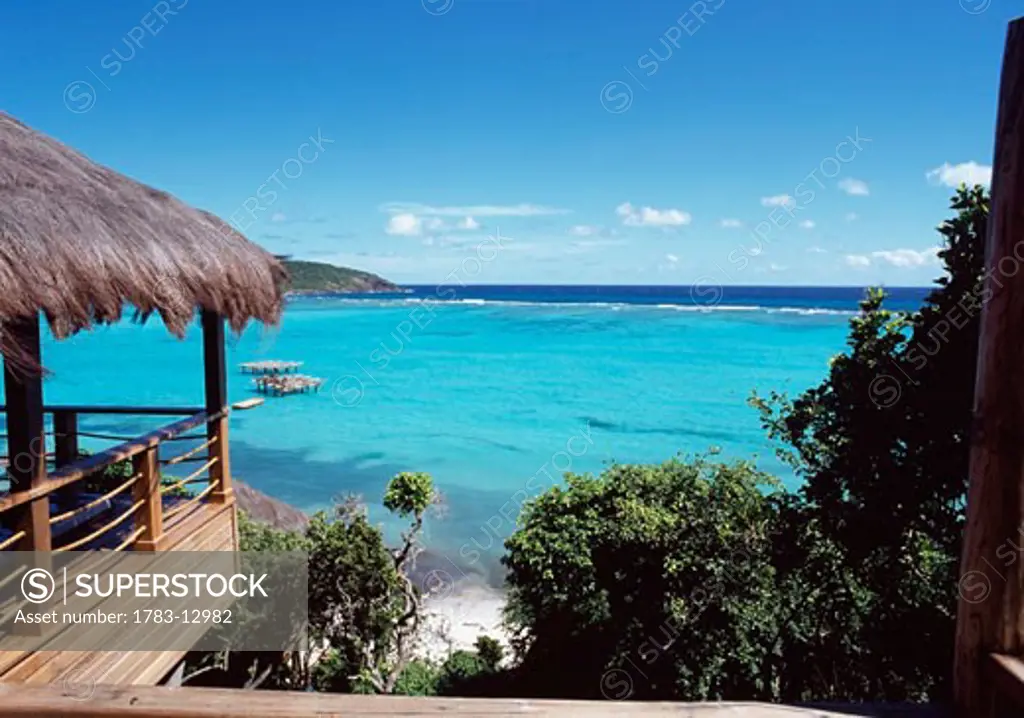 Thatched roof over balcony overlooking sea, Canouan, Grenadines.