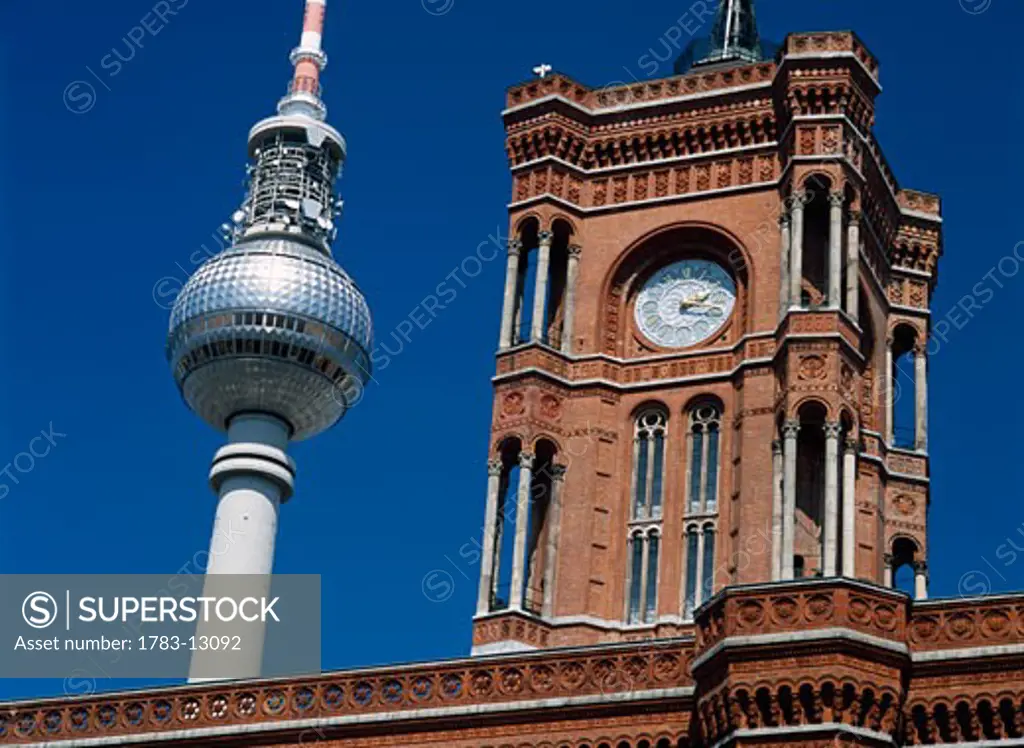 Clock tower of old building and Fernsehturm, Berlin, Germany.