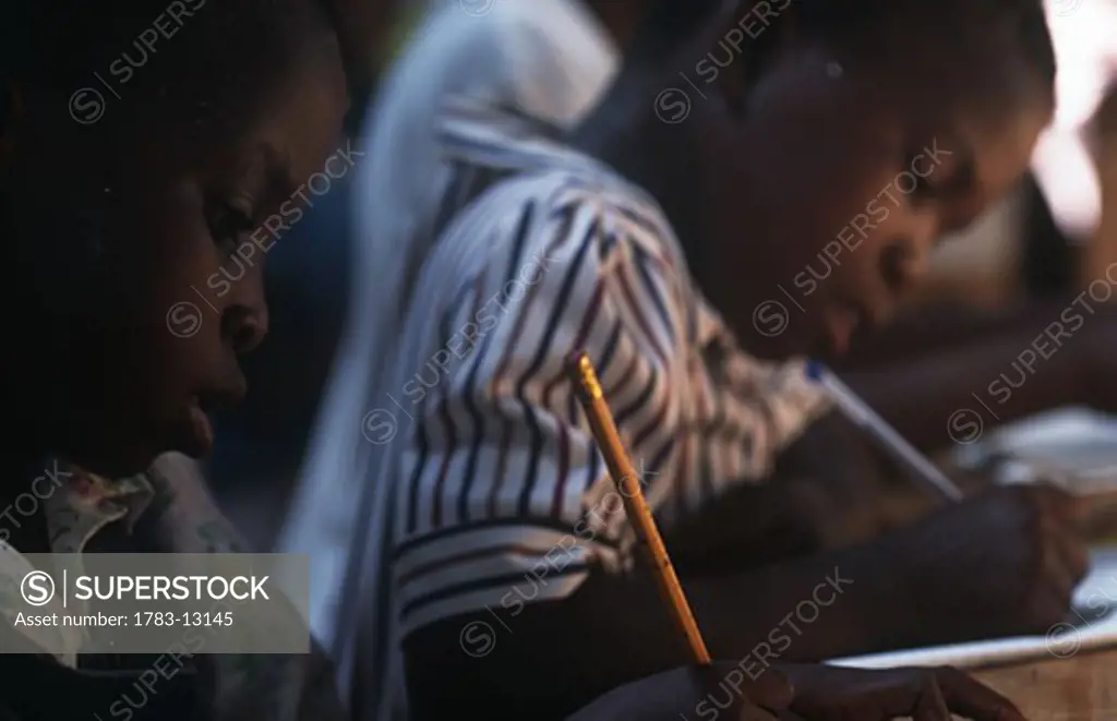 Young students writing at school  , Ghana.