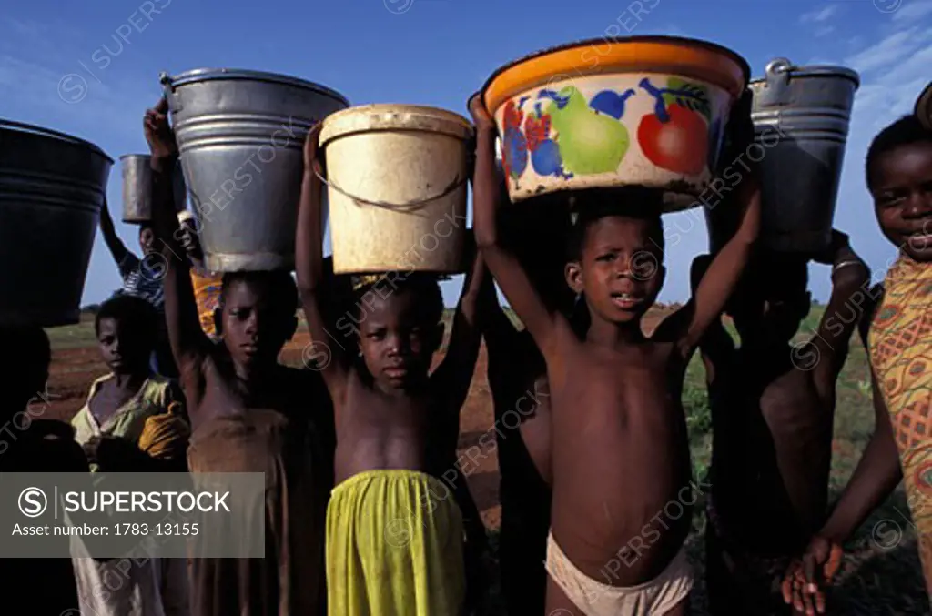Three children collecting water, Ghana.
