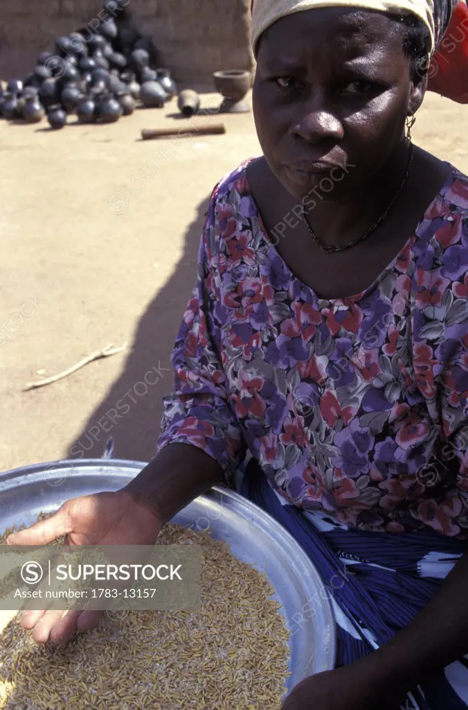 Woman polishing rice, Ghana.
