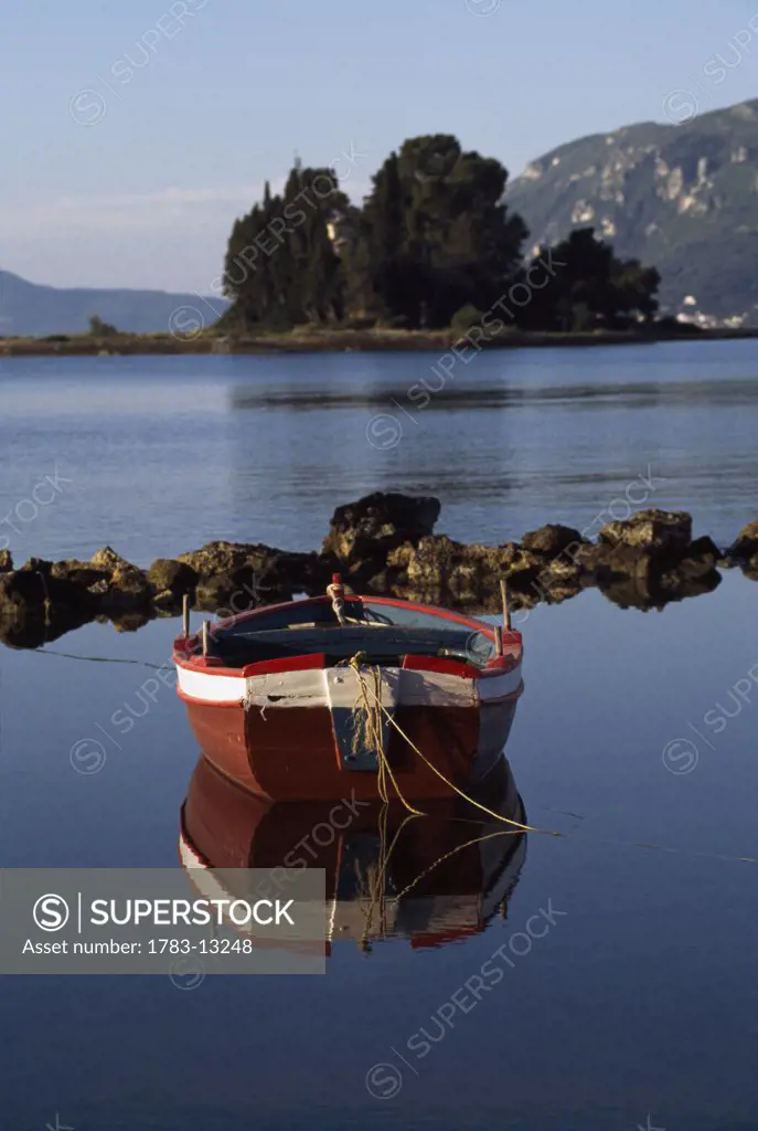 Single boat on estuary, Pondikonissi, Mouse Island, Corfu, Greece.