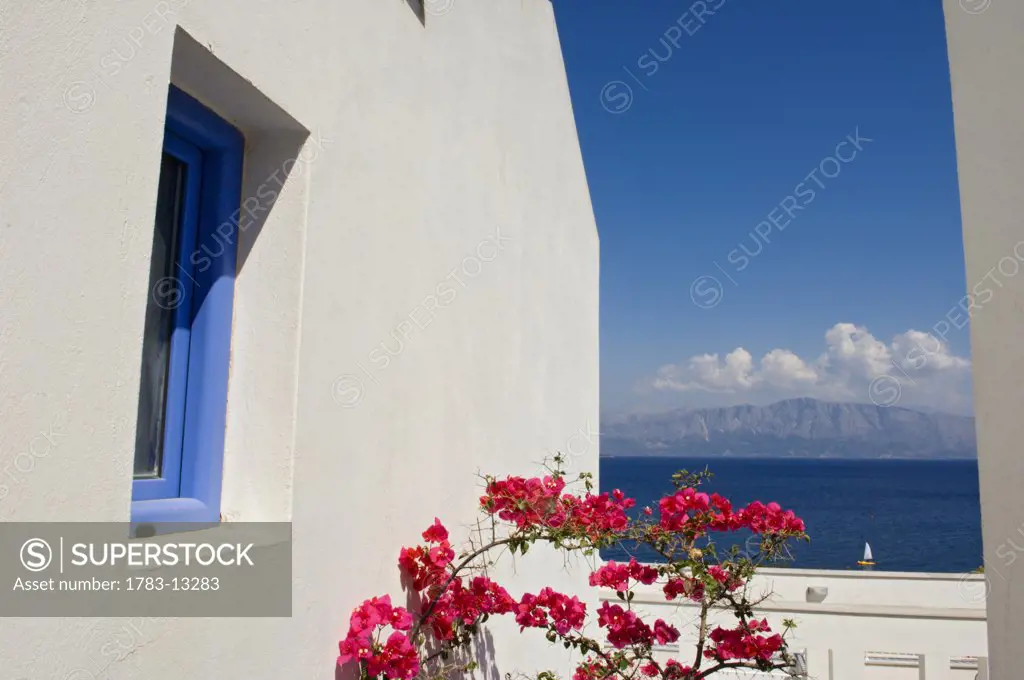 Balcony with pink blossomed flowers in resort overlooking some of the Ionian Islands. , View from Lefkas ( Lefkada ), Ionian Islands, Greece.