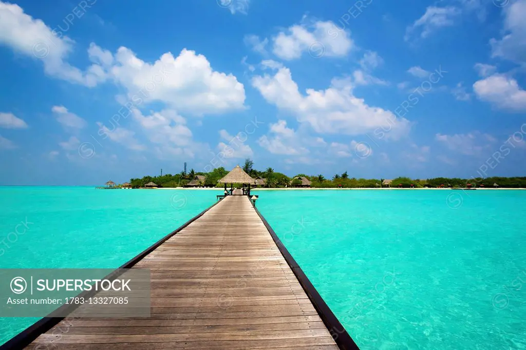 Jetty with cabana over crystal clear turquoise sea, Maldives