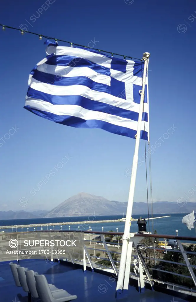 Greek flag on a ferry leaving port, Patras, Greece